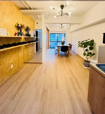 a kitchen and living room with a wooden floor at Kameido Wisteria Retreat 2 Floor in Tokyo