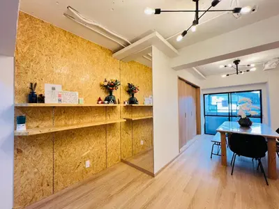 a dining room with a table and a yellow wall at Kameido Wisteria Retreat 2 Floor in Tokyo