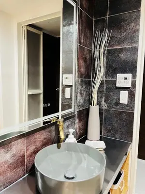 a bathroom with a sink and a mirror at Kameido Wisteria Retreat 2 Floor in Tokyo