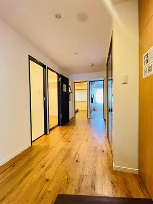 an empty hallway with wood floors and sliding glass doors at Kameido Wisteria Retreat 6 Floor in Tokyo