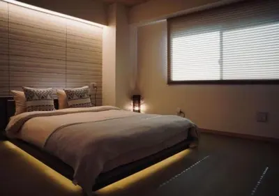 a bedroom with a large bed with a light on it at Kameido Wisteria Retreat 7 Floor in Tokyo
