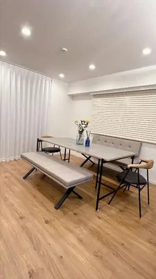 a table and bench in a room with a window at Kameido Wisteria Retreat 7 Floor in Tokyo