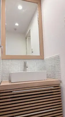 a bathroom with a white sink and a mirror at Kameido Wisteria Retreat 7 Floor in Tokyo
