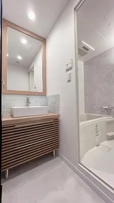 a bathroom with a sink and a tub and a mirror at Kameido Wisteria Retreat 7 Floor in Tokyo