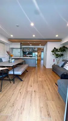a living room with a table and a couch at Kameido Wisteria Retreat 7 Floor in Tokyo
