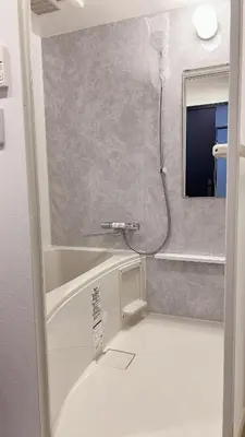 a bathroom with a shower with a mirror at Kameido Wisteria Retreat 7 Floor in Tokyo