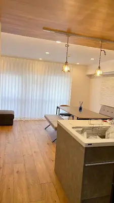 a living room with a kitchen and a table at Kameido Wisteria Retreat 7 Floor in Tokyo