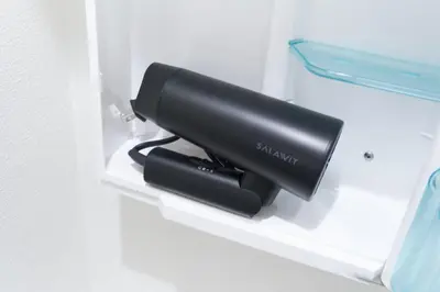 a black object sitting on a shelf in a refrigerator at Rio Grande Nishi-Shinjuku by Tranova in Tokyo