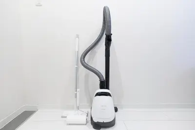 a black and white vacuum cleaner sitting on a floor at Rio Grande Nishi-Shinjuku by Tranova in Tokyo