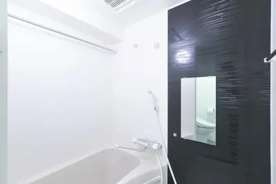 a bathroom with a tub and a sink and a mirror at Rio Grande Nishi-Shinjuku by Tranova in Tokyo