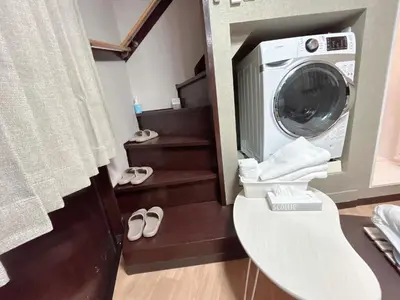 a washing machine in a bathroom with a toilet at \u6c60\u888b\u5de3\u9d28\u30cf\u30a6\u30b9\u4e00\u68df\u4e38\u3054\u3068\u8cb8\u5207\u308aIkebukuro Sugamo House-Private Entire Building in Tokyo