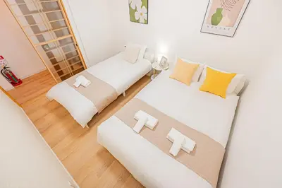 a room with two beds and a mirror at Mori hotel AKIHABARA 2 in Tokyo