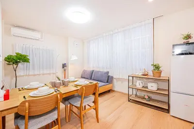 a kitchen and dining room with a table and a refrigerator at Mori hotel AKIHABARA 2 in Tokyo
