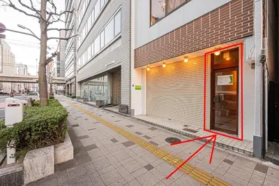 a store front with a red arrow on the sidewalk at Mori hotel AKIHABARA 2 in Tokyo