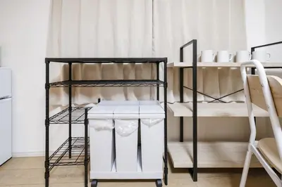 a black and white bunk room with two bunk beds at Shinjuku Raise OG House in Tokyo