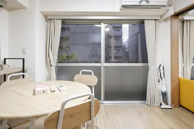 a dining room with a table and a large window at Shinjuku Raise OG House in Tokyo