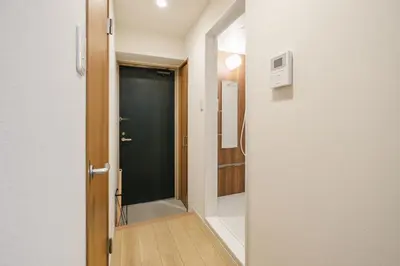 a hallway with a door leading to a bathroom at Shinjuku Raise OG House in Tokyo