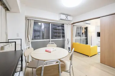 a kitchen and dining room with a table and chairs at Shinjuku Raise OG House in Tokyo