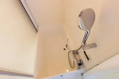 a bathroom with a toilet with a mirror on the wall at Natsumezaka Room2 NM2 in Tokyo