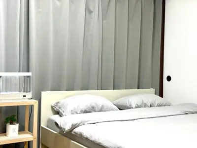 a bedroom with a bed with white sheets and pillows at Shinjuku\u5927\u4e45\u4fdd3 in Tokyo