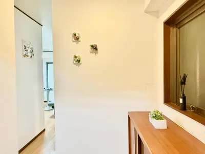 a room with a white wall with pictures on the wall at Shinjuku\u5927\u4e45\u4fdd3 in Tokyo