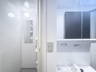 a white bathroom with a sink and a mirror at Ikebukuro Walking Street, 5 minutes from the station, 4-6 people in Tokyo
