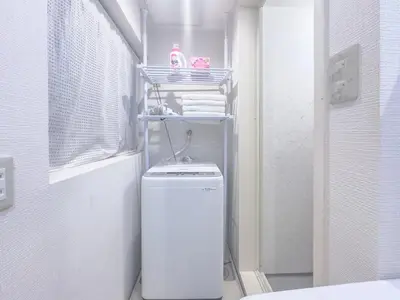 a bathroom with a toilet and a shelf with towels at Ikebukuro Walking Street, 5 minutes from the station, 4-6 people in Tokyo