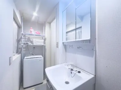 a white bathroom with a sink and a refrigerator at Ikebukuro Walking Street, 5 minutes from the station, 4-6 people in Tokyo