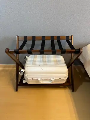 a suitcase is sitting on a wooden bench at Cozy Vintage Studio Asakusa Skytree Ueno Akihabara in Tokyo
