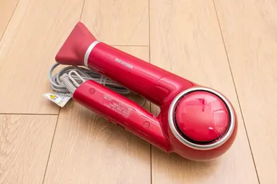 a red appliance sitting on top of a wooden floor at Cozy Vintage Studio Asakusa Skytree Ueno Akihabara in Tokyo