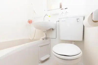 a white bathroom with a toilet and a sink at Cozy Vintage Studio Asakusa Skytree Ueno Akihabara in Tokyo