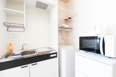 a kitchen with a sink and a microwave at Cozy Vintage Studio Asakusa Skytree Ueno Akihabara in Tokyo