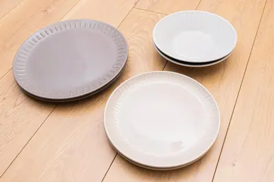 three white plates sitting on top of a wooden floor at Cozy Vintage Studio Asakusa Skytree Ueno Akihabara in Tokyo