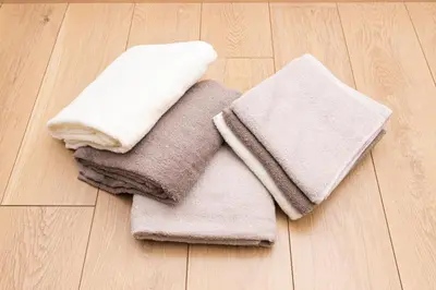 a pile of towels sitting on a wooden floor at Cozy Vintage Studio Asakusa Skytree Ueno Akihabara in Tokyo