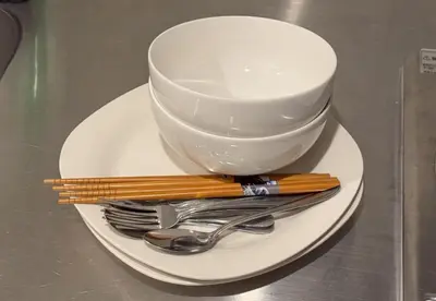 a white plate with a cup and forks and spoons at \u53f0\u6771\u533a\u53f0\u6771\u3067\u5feb\u9069\u306a\u5bbf\u6cca\u3092\u6d45\u8349 \u4e0a\u91ce\u89b3\u5149\u306e\u62e0\u70b9\u306b 201 in Tokyo
