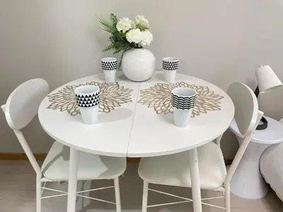 a white table with chairs and a white vase with flowers at COMMA HOUSE Kitaikebukuro 102 in Tokyo