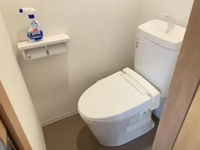 a bathroom with a white toilet and a bottle of cleaner at COMMA HOUSE Kitaikebukuro 102 in Tokyo