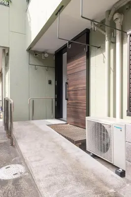 a front door of a building with a wooden door at Close to SHIBUYA! 6beds New & Comfortable Stay! in Tokyo