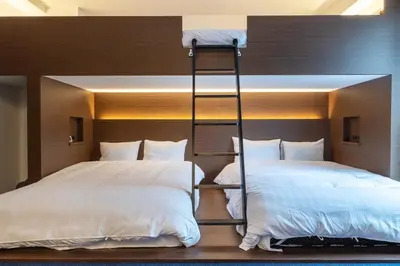 two beds in a room with two bunk beds at Close to SHIBUYA! 6beds New & Comfortable Stay! in Tokyo