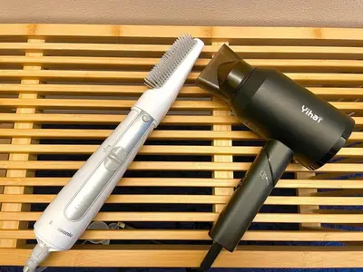 two hair brushes sitting on a wooden cutting board at Close to SHIBUYA! 6beds New & Comfortable Stay! in Tokyo