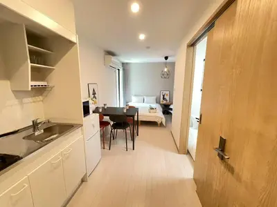 a kitchen and living room with a table and a bedroom at COMMA HOUSE Kitaikebukuro 103 in Tokyo