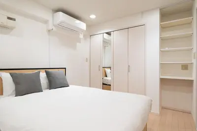 a bedroom with a white bed and a closet at Ms\u30d3\u30ebll in Tokyo