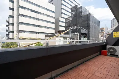 a balcony with a view of a building at Ms\u30d3\u30ebll in Tokyo