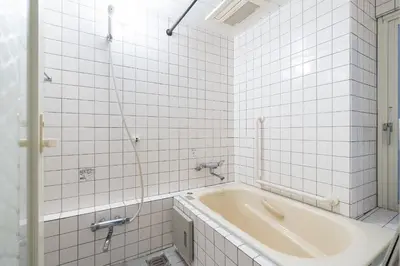 a bath tub in a bathroom with white tiles at Ms\u30d3\u30ebll in Tokyo