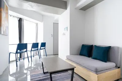 a living room with a couch and a table at \u795e\u6cc9 \u672c\u90e8\u30d3\u30eb in Tokyo
