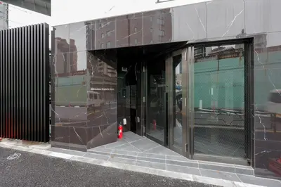 an entrance to a building with glass doors at \u795e\u6cc9 \u672c\u90e8\u30d3\u30eb in Tokyo