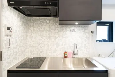 a kitchen with a sink and a counter top at \u795e\u6cc9 \u672c\u90e8\u30d3\u30eb in Tokyo