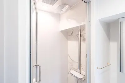 a shower with a glass door in a bathroom at \u795e\u6cc9 \u672c\u90e8\u30d3\u30eb in Tokyo