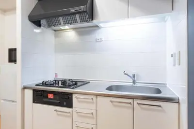 a kitchen with a sink and a stove at Daffitto\u5929\u738b\u6d32 in Tokyo
