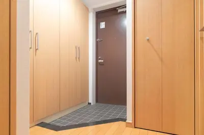 a door leading to a bathroom with a tile floor at Daffitto\u5929\u738b\u6d32 in Tokyo
